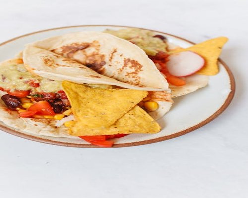 Healthy traditional Mexican meal with beans, fresh vegetables and corn tortillas